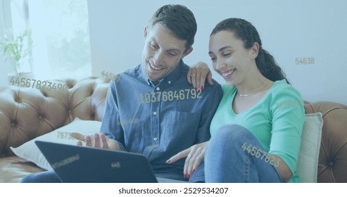 Image of data processing over caucasian couple using laptop. Global business and digital interface concept digitally generated image.