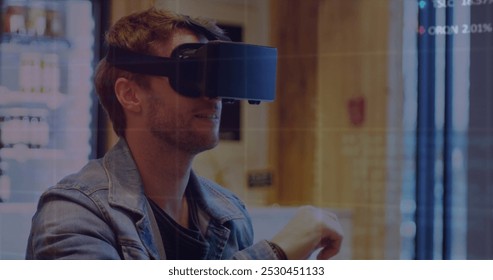Image of data processing over caucasian man using vr headset. Global business and digital interface concept digitally generated image.