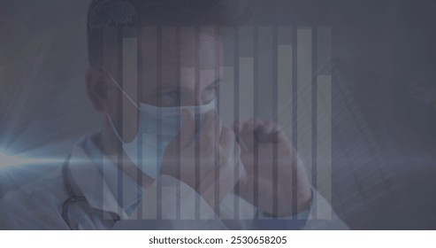 Image of data processing over caucasian male doctor with face mask. global medicine and data processing during covid 19 pandemic concept digitally generated image.