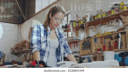 Image of data processing over caucasian female carpenter working in workshop. Global communication, work and digital interface concept digitally generated image.