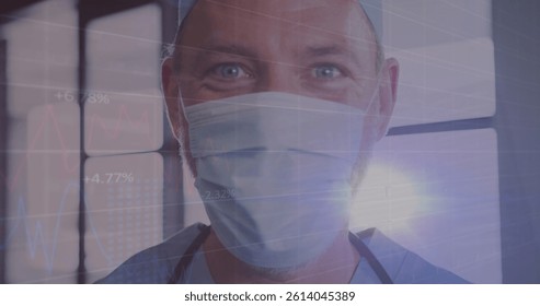 Image of data processing over caucasian male doctor with face mask. global medicine and data processing during covid 19 pandemic concept digitally generated image.