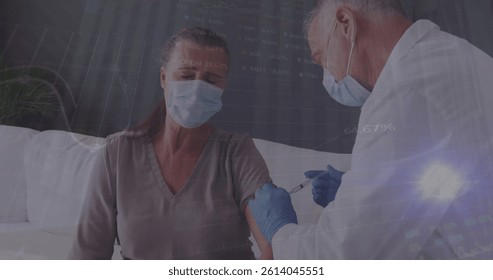 Image of data processing over caucasian male doctor with face mask vaccinating. global medicine and data processing during covid 19 pandemic concept digitally generated image.