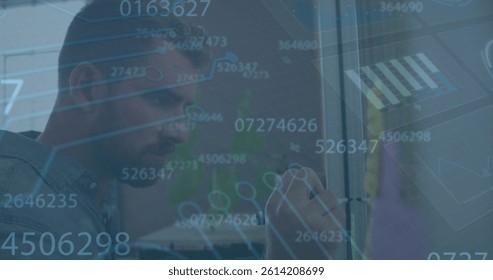 Image of data processing over caucasian businessman taking notes. global business, finances, connections and digital interface concept digitally generated image.