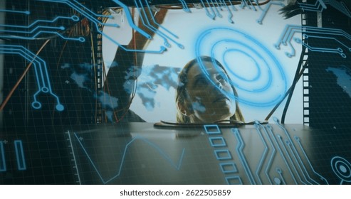 Image of data processing over caucasian man checking computer wires. computers, network, data processing and digital interface concept digitally generated image.
