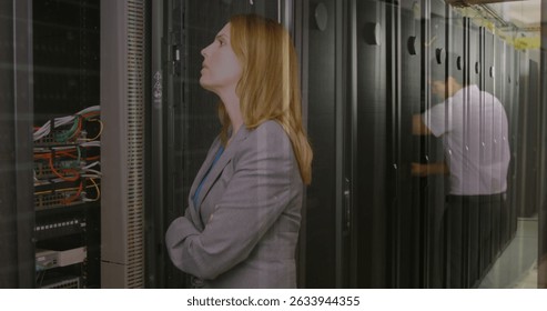 Image of data processing over caucasian woman in server room. Global business digital interface technology and networking concept digitally generated image.