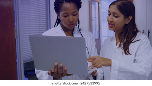 Image of data processing over diverse scientists using laptop. Global science, digital interface, computing and data processing concept digitally generated image.