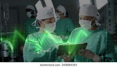 Image of data processing over diverse surgeons with tablet in hospital. Global medicine, healthcare, connections, computing and data processing concept digitally generated image. - Powered by Shutterstock - Get 15% off with code: PIKWIZARD15