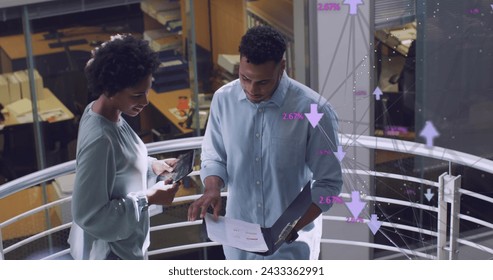 Image of data processing over diverse business people in office. Global business and digital interface concept digitally generated image.