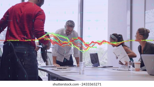 Image of data processing over diverse business people in office. Global business and digital interface concept digitally generated image.