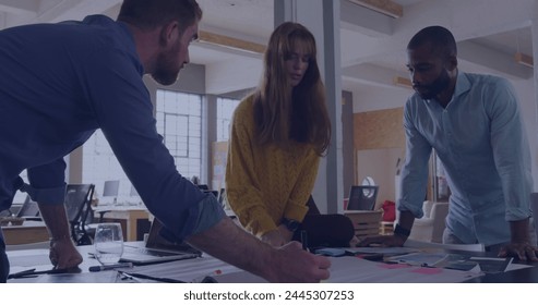 Image of data processing over diverse business people in office. Global business, digital interface, computing and data processing concept digitally generated image.