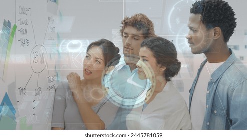 Image of data processing over diverse business people taking notes. global business and digital interface concept digitally generated image.