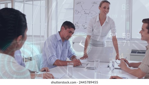 Image of data processing over diverse business people at meeting. global business and digital interface concept digitally generated image.
