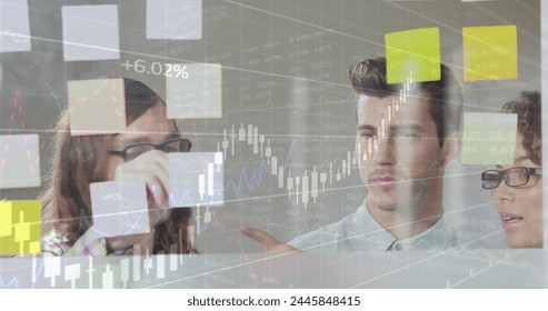 Image of data processing over diverse business people taking notes. global business and digital interface concept digitally generated image.