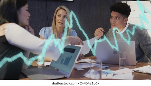 Image of data processing over diverse business people working in office. Global business, finances, computing and data processing concept digitally generated image.