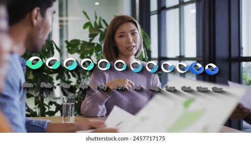 Image of data processing over diverse business people at meeting. Global business and digital interface concept digitally generated image.