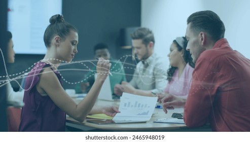 Image of data processing over diverse business people in office. Global business and digital interface concept digitally generated image.