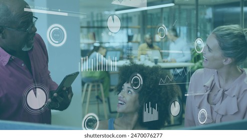 Image of data processing over diverse colleagues discussing together at office. Computer interface and business technology concept
