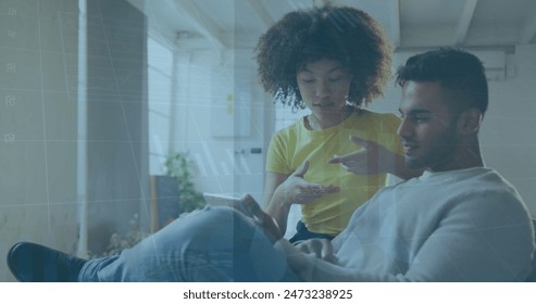 Image of data processing over diverse business people working in office. Global business and digital interface concept digitally generated image.