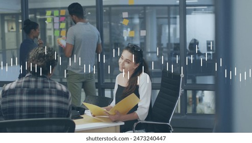 Image of data processing over diverse male and female colleagues discussing at office. Business data technology concept