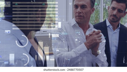 Image of data processing over diverse business people at office. Global business, computing and digital interface concept digitally generated image.