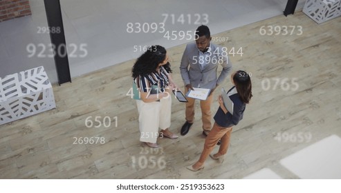 Image of data processing over diverse business people discussing work. Global business, technology and digital interface concept digitally generated image.