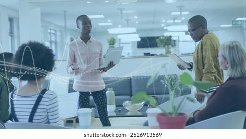 Image of data processing over diverse business people in office. Global business and digital interface concept digitally generated image.