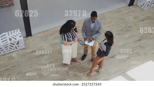 Image of data processing over diverse business people in office. Global finance, business, connections, computing and data processing concept digitally generated image.