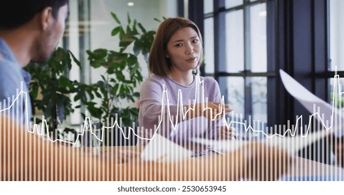 Image of data processing over diverse colleagues discussing work in office. Business, communication, technology, computing and digital interface concept digitally generated image.