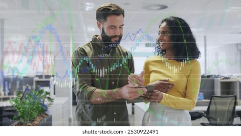 Image of data processing over diverse business people working at office. Global business and digital interface concept digitally generated image.