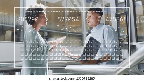 Image of data processing over diverse business people working at office. Global business and digital interface concept digitally generated image.