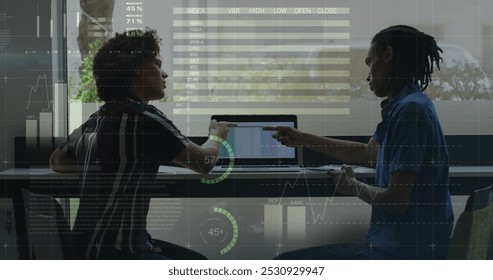 Image of data processing over diverse business people using laptop. social media and communication interface concept digitally generated image.