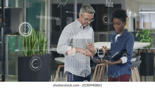 Image of data processing over diverse business people in office. Global business and digital interface concept digitally generated image.