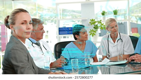 Image of data processing over diverse doctors at meeting. Medicine, technology and digital interface concept digitally generated image.