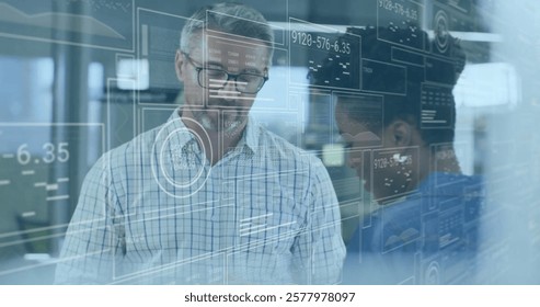 Image of data processing over diverse colleagues discussing work in office. Global business, finances, communication and digital interface concept digitally generated image.