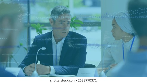 Image of data processing over diverse business people talking. Global business and digital interface concept digitally generated image.