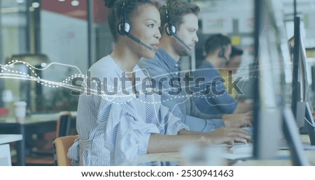Image of data processing over diverse business people working in office. Global business and digital interface concept digitally generated image.