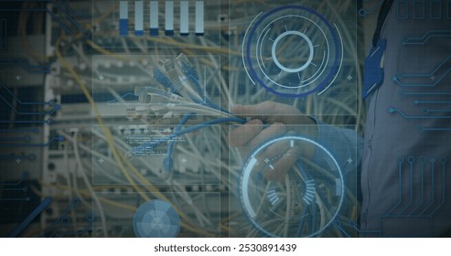 Image of data processing over hands of caucasian male engineer connecting wires. computers, network, data processing, technology and digital interface concept digitally generated image.
