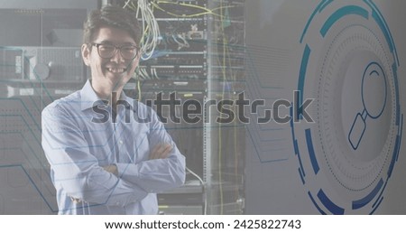 Image of data processing over happy asian male worker in server room. Global business and digital interface concept digitally generated image.