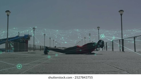 Image of data processing over man doing press ups, exercising outdoors. Global sports, fitness, computing and data processing concept digitally generated image.