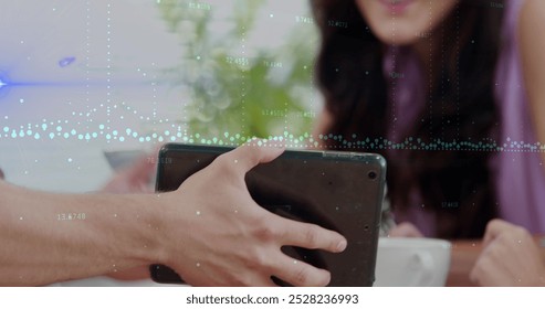 Image of data processing over people using tablet. Global business, finances, data processing and digital interface concept digitally generated image.