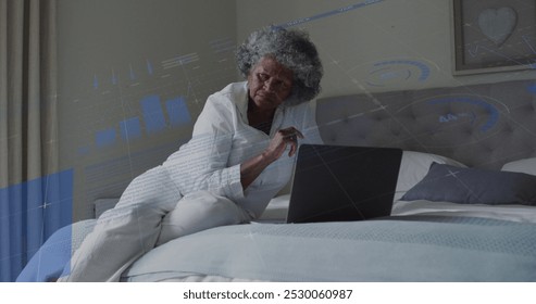 Image of data processing over senior african american woman using laptop. Global connections, communication and data processing concept digitally generated image. - Powered by Shutterstock