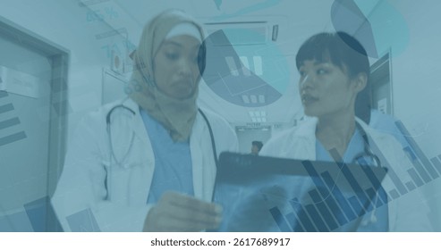 Image of data processing over two diverse female doctors. global science, connections, data processing and digital interface concept digitally generated image.