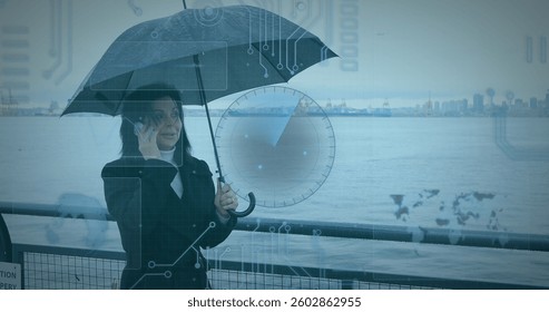 Image of data processing over woman using smartphone carrying umbrella in background. digital interface, global connection and communication concept digitally generated image.