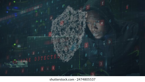 Image of data processing and shield with padlock over african american male hacker using laptop. cloud computing and data processing concept digitally generated image.