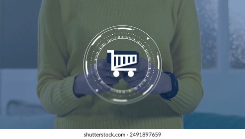 Image of data processing and shopping trolley symbol over caucasian woman using smartphone. Global finance, business, connections, computing and data processing concept digitally generated image.