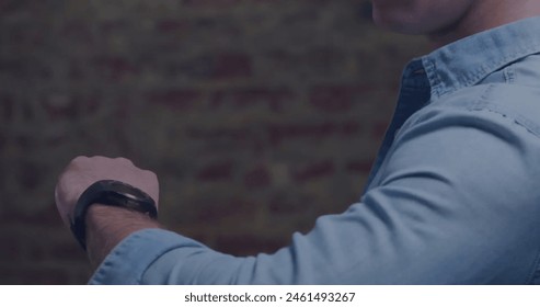 Image of data processing and stock market over caucasian man using smartwatch. Global business and digital interface concept, digitally generated image. - Powered by Shutterstock