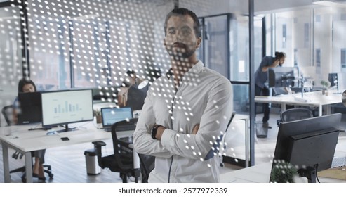 Image of data processing, world map over biracial businessman with arms crossed in office. Global business and digital interface concept digitally generated image.