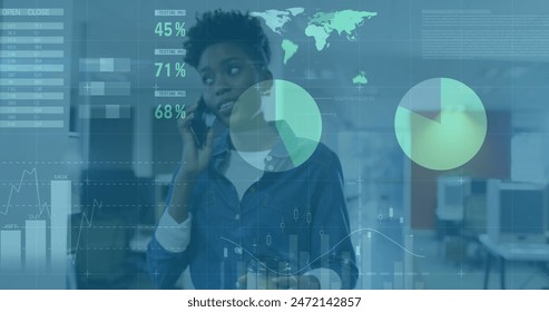 Image of data processsing against african american woman talking on smartphone at office. Computer interface and business data technology concept