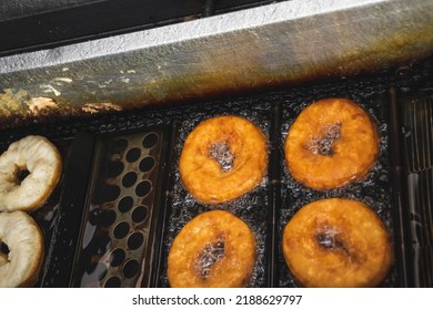 Image Of Deep Fried Unhealthy Donut. Saturated Fats Carcinogenic Doughnouts Industry. Mass Production Of Processed Food Concept.