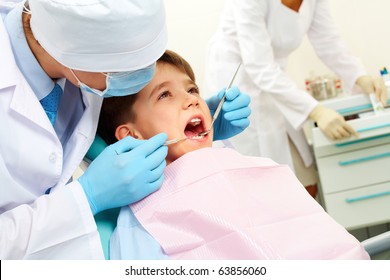 Image of dental examining being given to little boy by dentist - Powered by Shutterstock